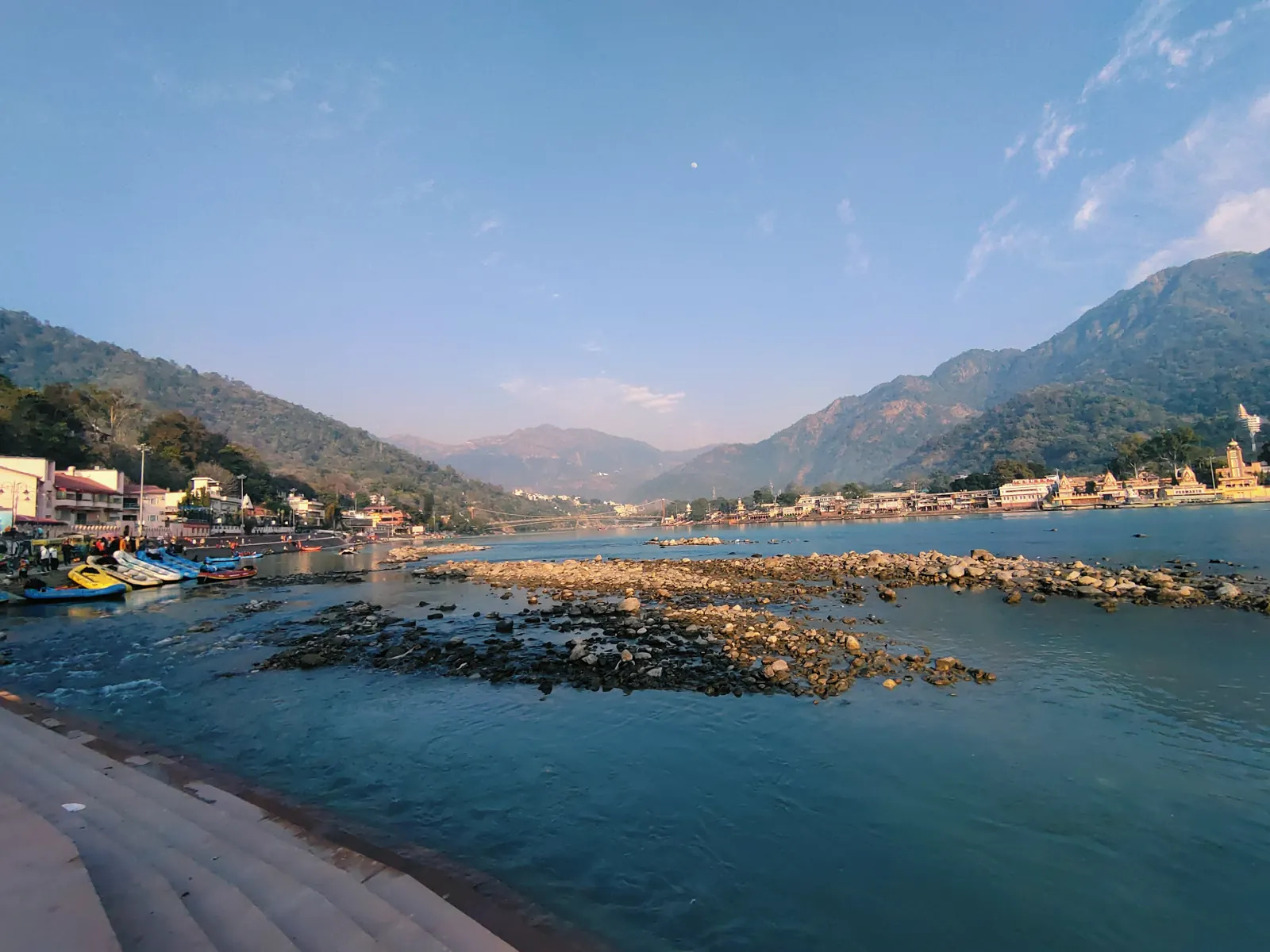 The ghat and boats at Rishikesh with the foothills behind